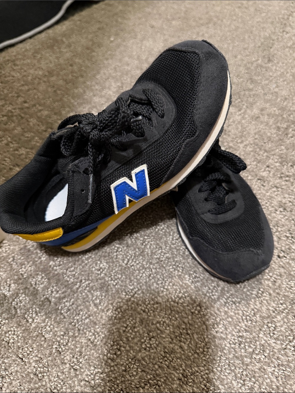 New Balance Black Sneakers with Blue and Yellow Details